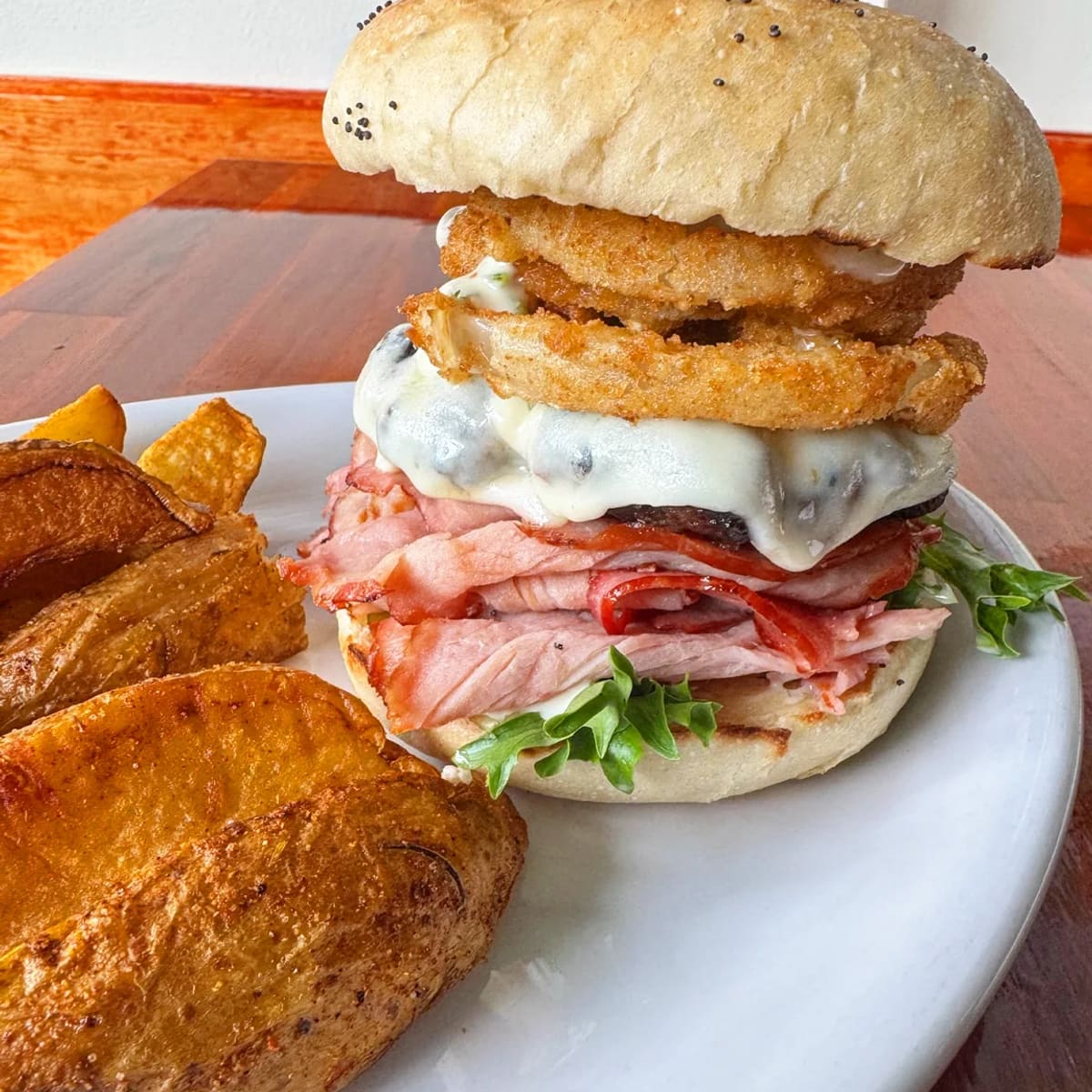The Casanova burger stacked with crispy ham, onion rings and provolone